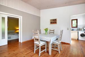 a kitchen and dining room with a table and chairs at Ferienhaus 'kiek op de Beek' in Langballig