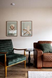 a living room with a couch and a chair at Lakeside Villas at Crittenden Estate in Dromana