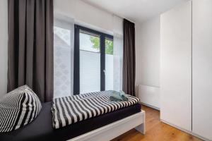 a room with a window with a zebra print bed at Casa Caso - Apartment 1 in Achim