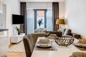 a living room with a table and chairs and a living room at Casa Caso - Apartment 1 in Achim