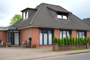 a red brick house with a black roof at Casa Caso - Apartment 1 in Achim