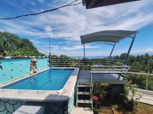 a swimming pool on top of a house at Island samal overlooking view house with swimming pools in San Antonio