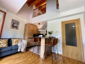 a living room with a blue couch and a table at Prime Loft LA RIOJA in Azarrulla