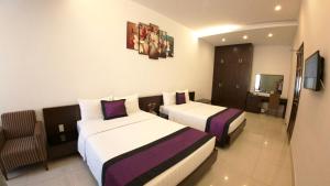 Postel nebo postele na pokoji v ubytování Ngoc Linh Luxury Hotel
