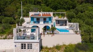 a house with a swimming pool on top of it at Casa GENI-heated pool, 3 bedrooms, sea views in Omiš