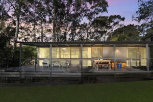 a screened in porch of a house with a table and chairs at Secluded 3-Bed Retreat Moments to the Beach in Surf Beach