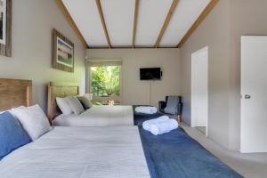 a living room with a bed and a couch at Secluded 3-Bed Retreat Moments to the Beach in Surf Beach