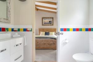 a bathroom with a sink and a bed at Secluded 3-Bed Retreat Moments to the Beach in Surf Beach +40 photos