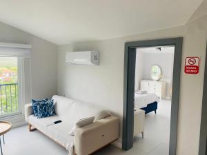 a living room with a couch and a bed at Airport Blue Eye Apartment Dalaman best Location also suitable for day rentals ideal for air travelers, 5 km close to airport in Dalaman
