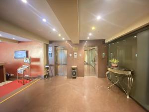 a large room with a lobby with a desk at Astoria Hotel in Kolkata