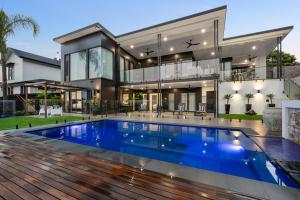a house with a swimming pool in front of it at Ridge Retreat in Toowoomba