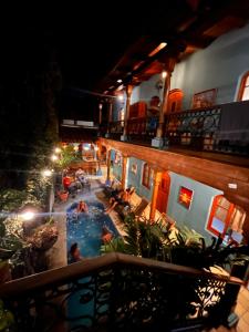 a view of a swimming pool at a hotel at night at Hotel Mirna & OCT in Granada