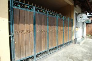 a wooden gate in front of a building at Belvilla 93916 Budi House Near Ubud Palace in Ubud