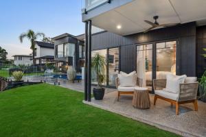a house with a yard with two chairs at Ridge Retreat in Toowoomba