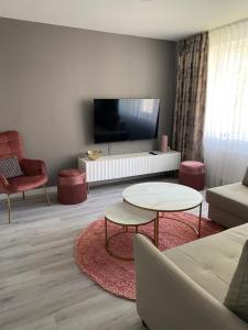 a living room with a couch and a table at Marijos apartamentai in Birštonas