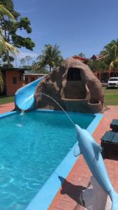 a fake dolphin in the water in a pool at Villas La Romana #2 in La Ceiba