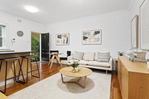 a living room with a couch and a table at Victorian Apartment in Lifestyle Hotspot in Sydney