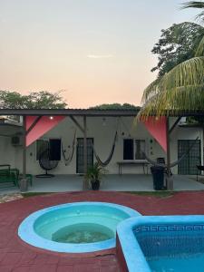 a pool in front of a house with a patio at Villas La Romana #2 in La Ceiba