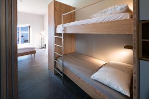 a bunk bed room with two bunk beds in it at Casa Moscia in Ascona