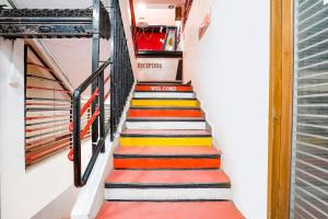 a stairway with colorful steps in a building at FabHotel Saroj Inn in Nashik