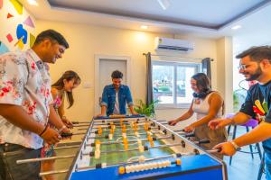a group of people playing a game of billiard at The Social Stays Rishikesh in Rishīkesh