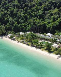 an aerial view of a beach with houses and trees at Thanya Beach Resort - SHA Plus in Ko Ngai