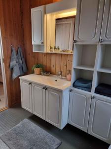 a bathroom with a sink and a mirror at Cozy Summer House In Lnstrup For 5 People, in Lønstrup