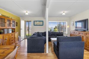 a living room with two couches and a tv at Carrickalinga SeaHaven in Normanville