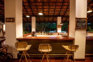 a bar with wicker chairs in a restaurant at Sigiriya Village in Sigiriya