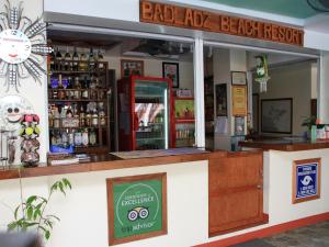 a bar at a beach resort with a sign at Badladz Staycation Condos in Puerto Galera