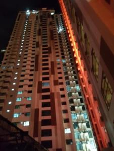 a tall building with lights on it at night at Studio Work Living Horizon 101 in Cebu City