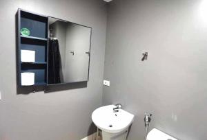 a white bathroom with a sink and a mirror at Studio Work Living Horizon 101 in Cebu City +19 photos