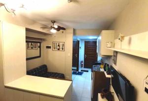 a kitchen and a living room with a couch at Studio Work Living Horizon 101 in Cebu City