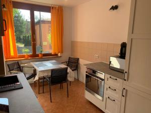 a kitchen with a table and a dining room at Apartament za ratuszem in Tarnowskie Góry