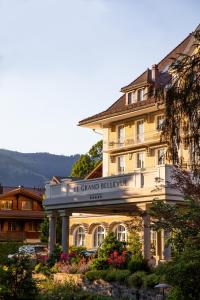 a building with a sign for the grand hotel at Le Grand Bellevue in Gstaad