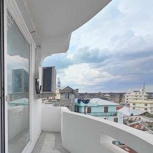 a white balcony with a view of the city at Ayaa Luxury Apartment 3rd Floor Zanzibar in Ngambo