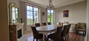 a dining room with a table and chairs at Villa Ardjoeno in Mandelieu-la-Napoule