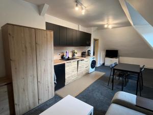 a small kitchen with a table and a dining room at Stay Adventure Mrzeżyno in Mrzeżyno