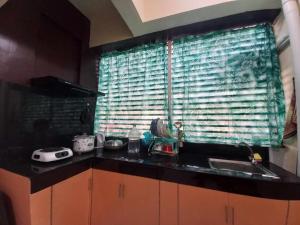 a kitchen counter with a sink and a window at Condo for Rent - Cagayan de Oro in Cagayan de Oro