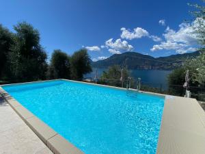 a swimming pool with a view of a lake at Casa Maya in Brenzone sul Garda