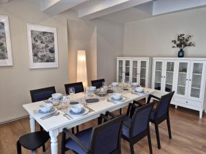 a dining room with a white table and chairs at Pärnu Old Town apartment in Pärnu +24 photos
