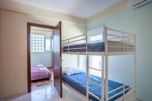 a bedroom with two bunk beds and a doorway at Betty seaside villa in Pefkochori