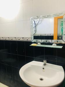 a bathroom with a white sink and a mirror at 97 Ella in Ella