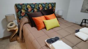 a couch with pillows on top of it at Tiempo de Cerezas in Cabezuela del Valle