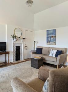 a living room with a couch and a fireplace at Humphries Cross Apartments in Rye