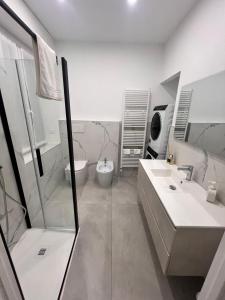 een badkamer met een douche, een wastafel en een toilet bij Appartamento The Twins in Asti