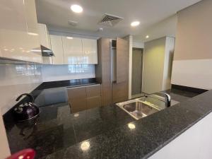 a kitchen with a sink and a counter top at 2 Luxury bedroom Apartment In Amwaj Island in Qalānī