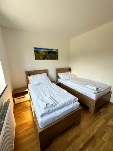 מיטה או מיטות בחדר ב-Penzion Mlyn - Bystra