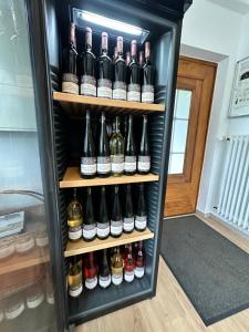a refrigerator filled with lots of bottles of wine at Ferienwohnungen Weingut Kilburg in Brauneberg