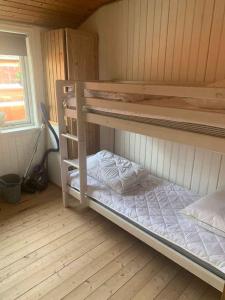 a room with two bunk beds in a cabin at Summer House With Shelter And Water View in Løgstør